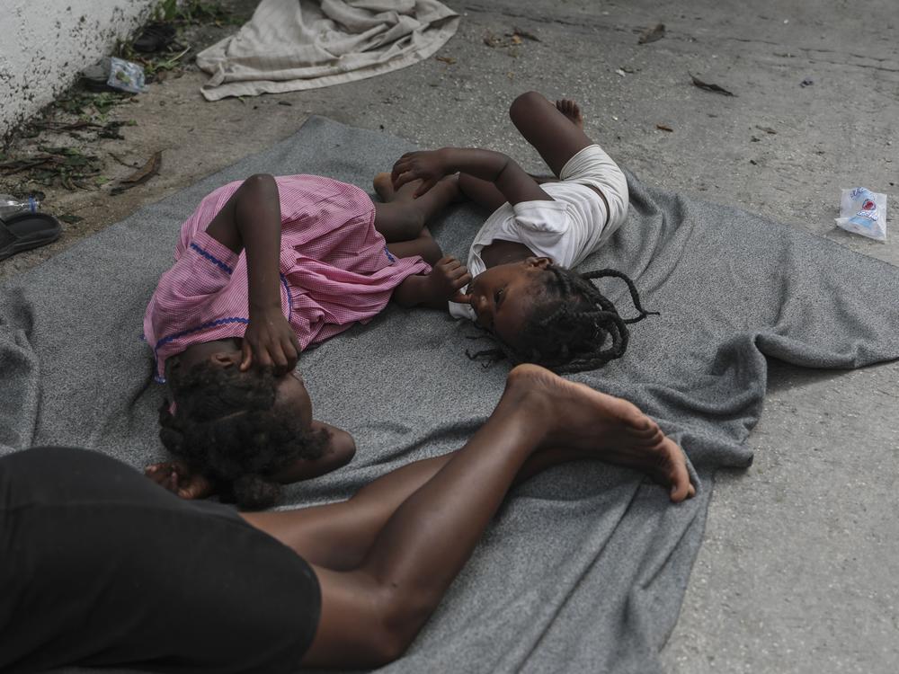 Children sleep on the floor at a school where residents of the Nazon neighborhood displaced by gang violence have sought refuge, in Port-au-Prince, Haiti on Thursday.