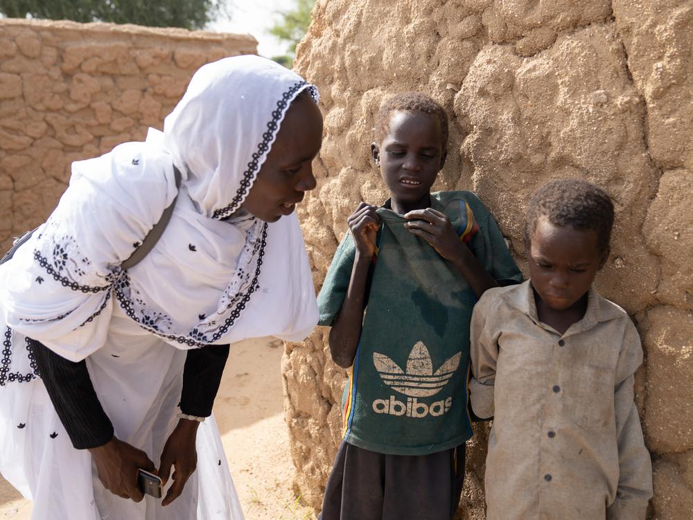 <strong>Maqboula Ahmad Adam, a Sudanese refugee who volunteers with World Vision, says she checks in on Mahamat and his brothers a few times a week. 