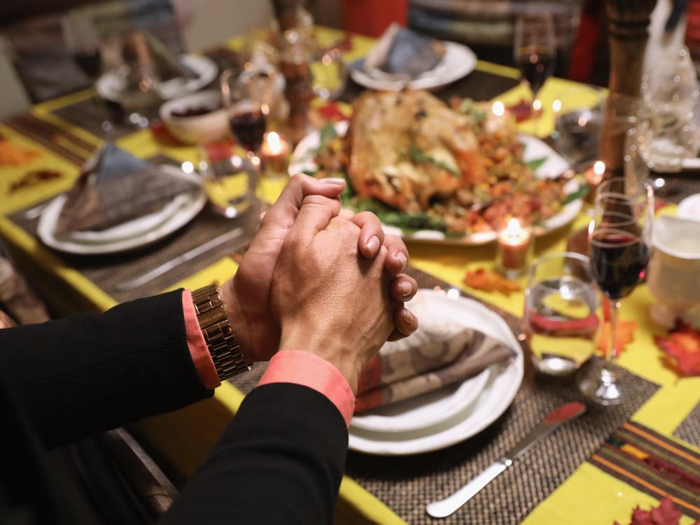 Central American immigrants and their families pray before Thanksgiving dinner on Nov. 24, 2016 in Stamford, Connecticut.