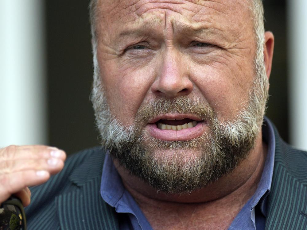 Right-wing conspiracy theorist Alex Jones speaks outside the federal courthouse after a June bankruptcy hearing in Houston.