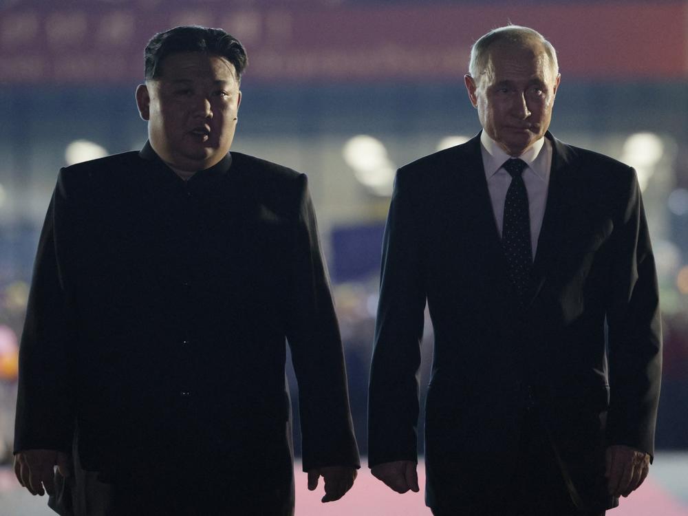 In this pool photograph distributed by the Russian state agency Sputnik, Russian President Vladimir Putin, right, and North Korean leader Kim Jong Un walk during a farewell ceremony upon Putin's departure at the Sunan International Airport in Pyongyang on June 19.