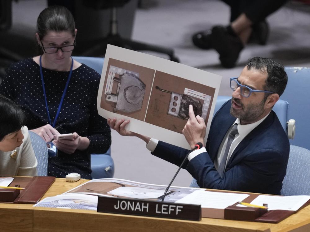 Jonah Leff, executive director at Conflict Armament Research (CAR), shows pictures of debris from armaments used by Russia, found in Ukraine, during a Security Council meeting at United Nations headquarters on June 28, 2024. CAR's findings indicate the weapons were made in North Korea.
