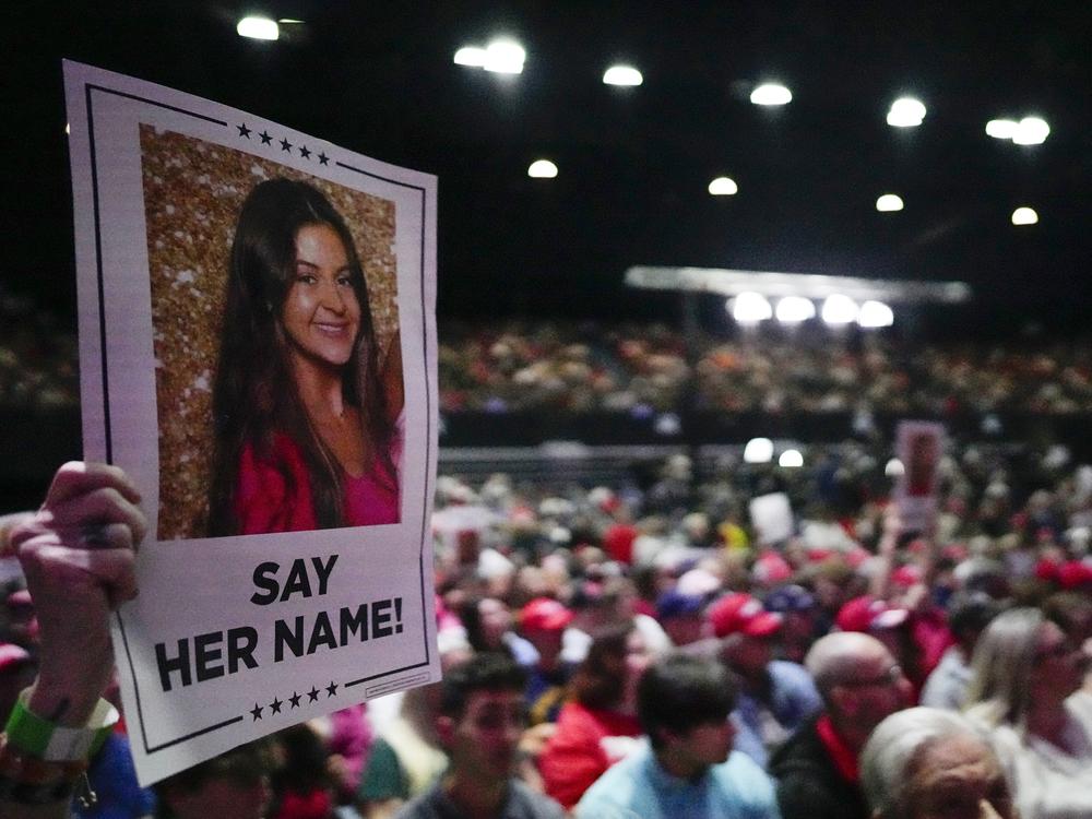 A supporter holds a sign with a photo of Laken Riley before former President Donald Trump speaks at a campaign rally on March 9 in Rome, Ga.