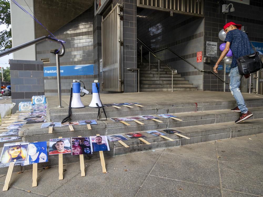 Photographs of individuals who died from overdoses are displayed outside Huntington Station in the Kensington neighborhood of Philadelphia during International Overdose Awareness Day on Aug. 29, 2024.