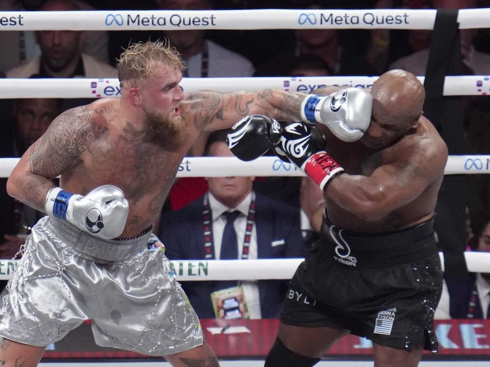 Jake Paul lands a left to Mike Tyson during their heavyweight boxing match on Friday in Arlington, Texas.