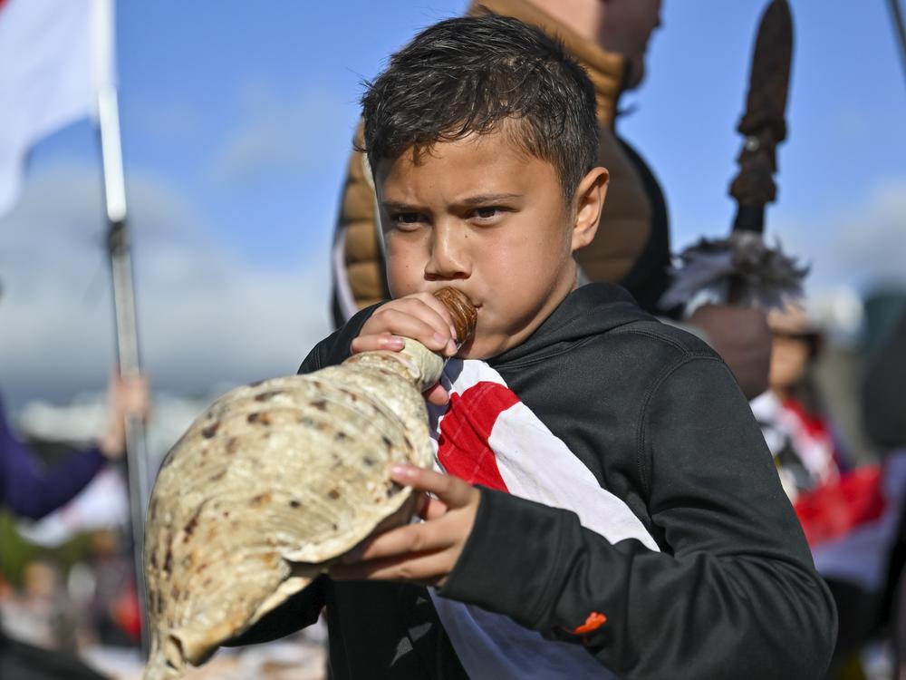 Te Haukūnui Hokianga plays a conch shell ahead of a protest at New Zealand's parliament against a proposed law that would redefine the country's founding agreement between Indigenous Māori and the British Crown, in Wellington, New Zealand on Tuesday.