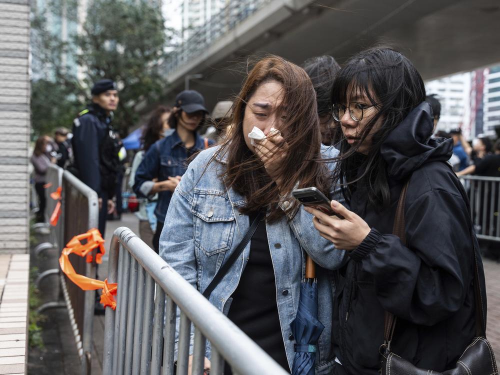 People leave the West Kowloon Magistrates' Courts in Hong Kong Tuesday, Nov. 19, 2024, following the sentencing in national security case.