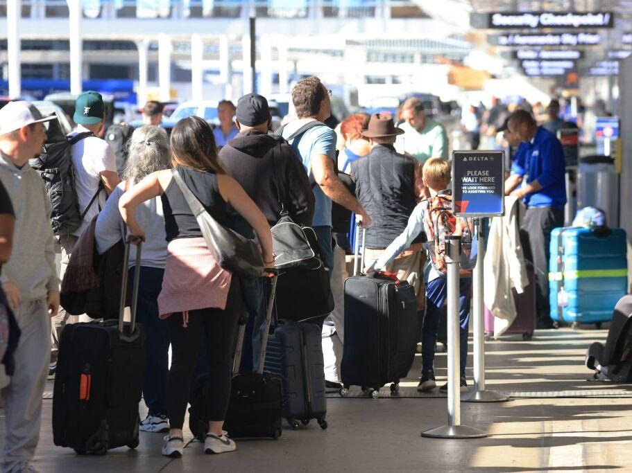 Crowds wait in checking line at Los Angeles International Airport on Nov. 21, 2023, in Los Angeles, as people travel ahead of the Thanksgiving holiday.