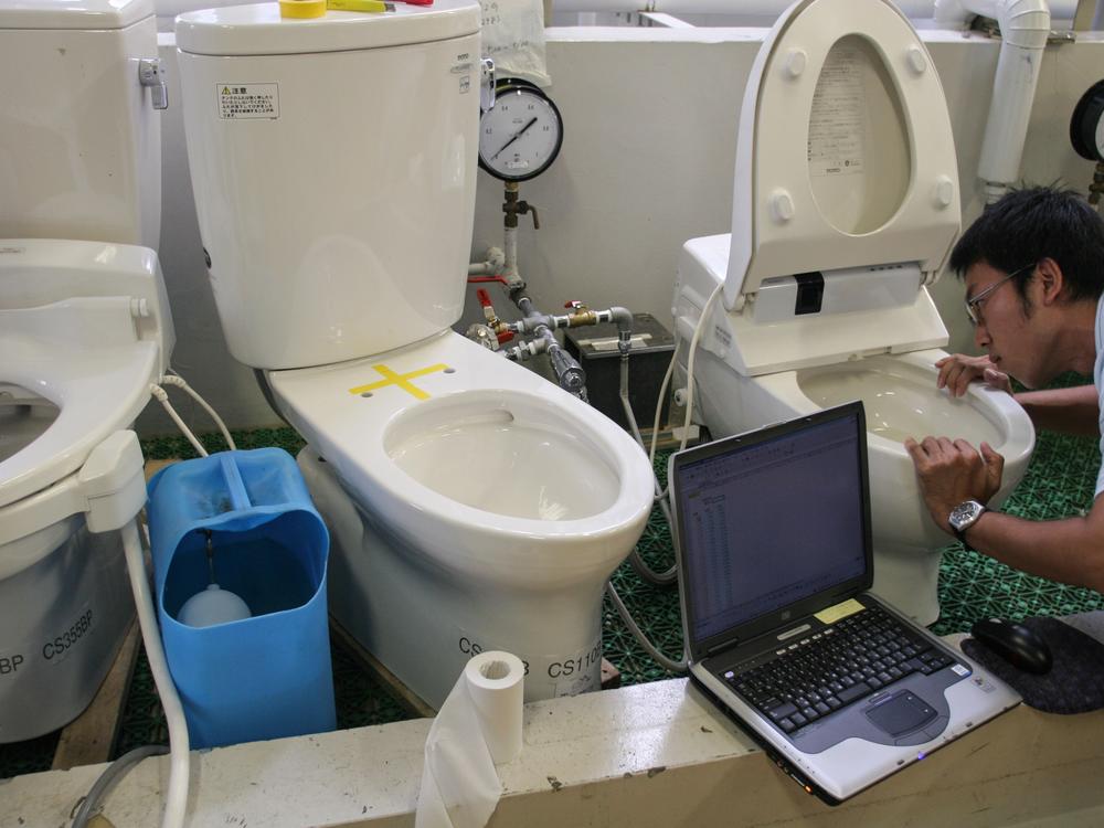 Toto toilets are known for their amenities — a heated seat, a mist-generated to remove fecal particles, a butt-washing spray. Here, an employee checks the water functions of various types of toilets in Toto's research laboratories in Kokura, Japan.