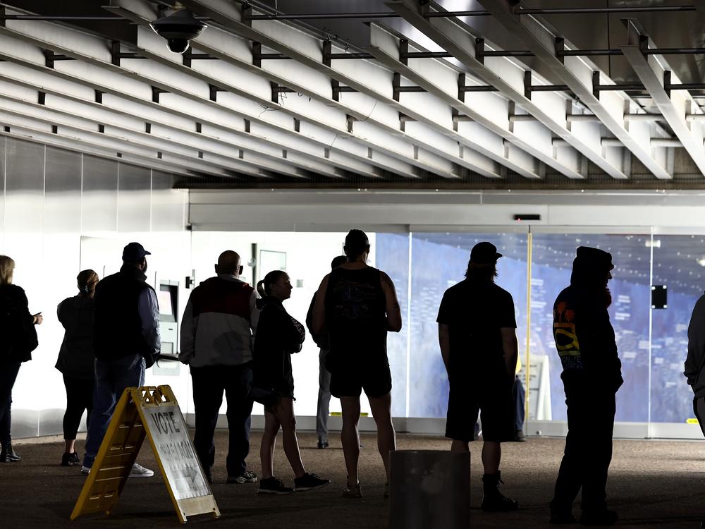 Voters wait in line to cast their ballots at Burton Barr Central Library before the polls open on Nov. 5 in Phoenix. President-elect Donald Trump won Arizona and the presidency, and he's on track to become the first Republican in two decades to win the national popular vote.