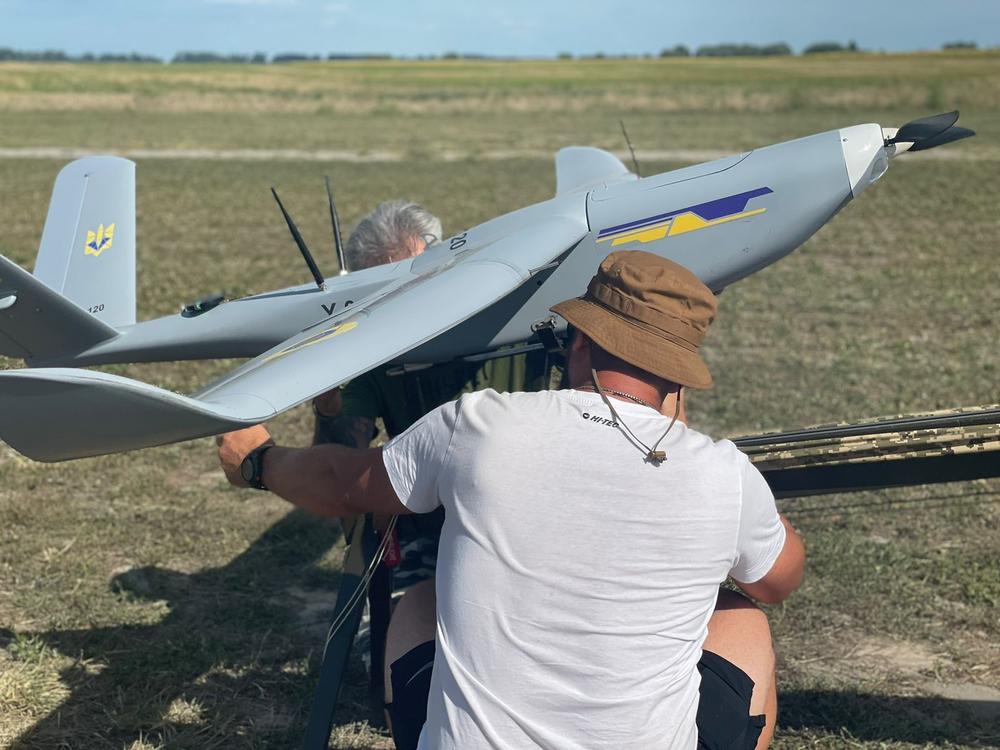 Ukrainian workers prepare a reconnaisance drone for a test flight outside of Kyiv in August. The drones are made by Airlogix, one of dozens of Ukrainian companies that began making the uncrewed aircraft after Russia's full-scale invasion in 2022. The drones are now a key part of Ukraine's war effort.