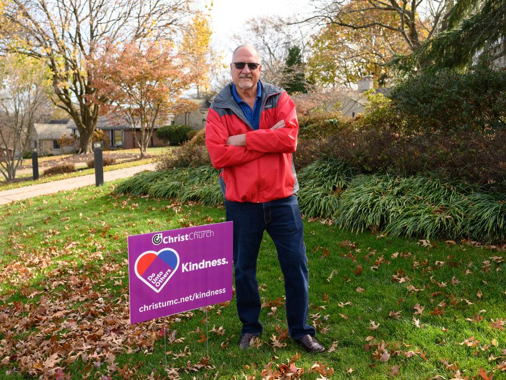 Bob Lewis, a member of Christ United Methodist Church, stands in his yard next to a 