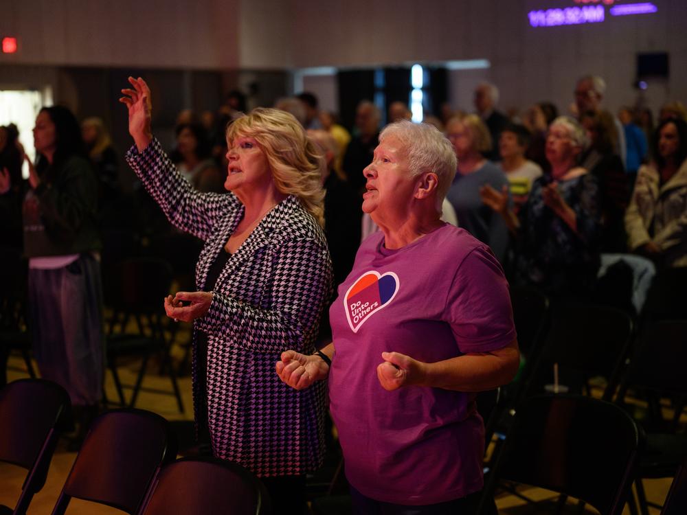 Betty Preite (left) and Bonnie Wieland sing along with a six-piece rock band during a contemporary service at Christ United Methodist Church. The sprawling church complex covers 2 acres and features four services each weekend.