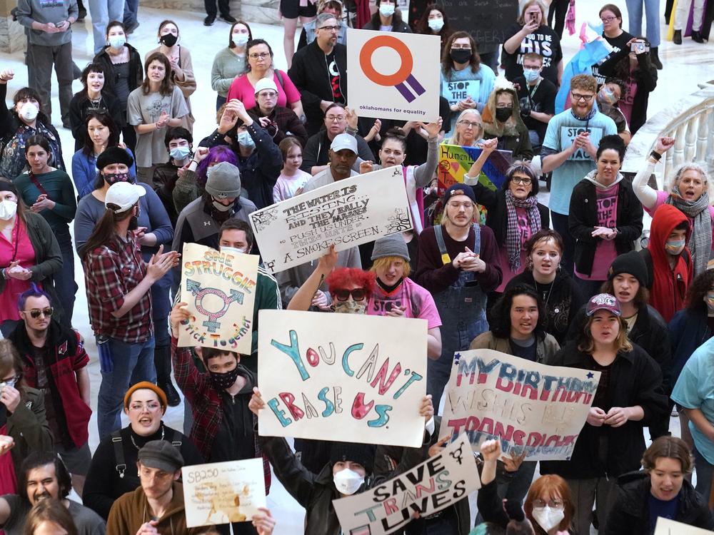 Trans-rights activists protest outside the House chamber at the Oklahoma state capitol before the State of the State address, Feb. 6, 2023, in Oklahoma City. Oklahoma and 25 other states have anti-trans laws on the books.