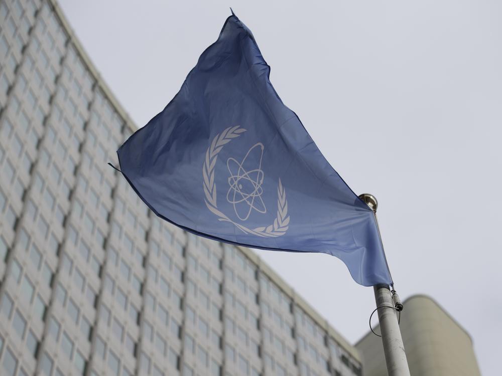 The flag of the International Atomic Energy Agency flies in front of its headquarters during an IAEA Board of Governors meeting in Vienna, Austria.