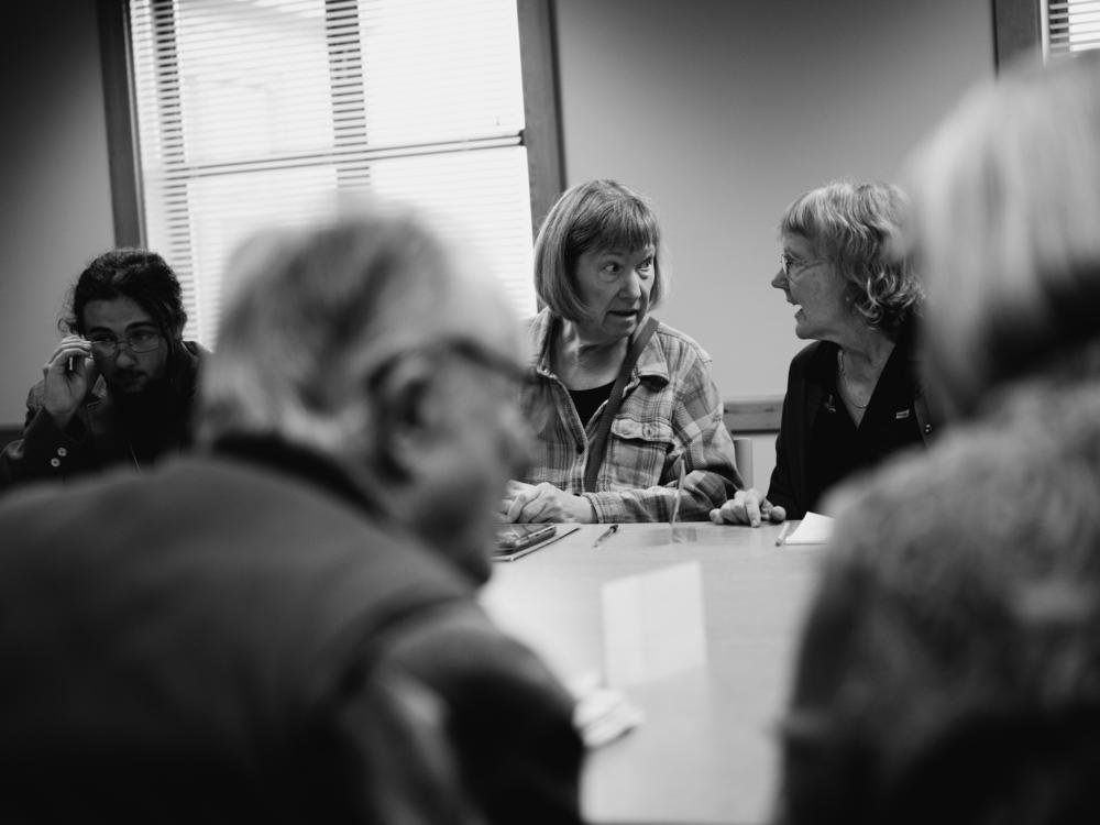 Kim Butler (left) and Pam Blakeman talk details on policy as a break begins during a meeting of the weekly political discussion group in Port Angeles.