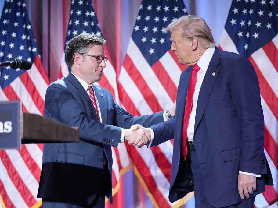 U.S. Speaker of the House Mike Johnson shakes hands with U.S. President-elect Donald Trump at a House Republicans Conference meeting at the Hyatt Regency on Capitol Hill on Nov. 13, 2024 in Washington.