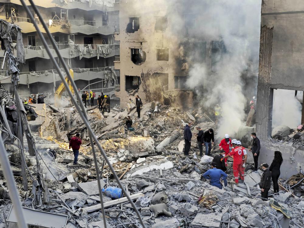 Rescue workers and people search for victims at the site of an Israeli airstrike in Beirut, Lebanon, on Saturday.