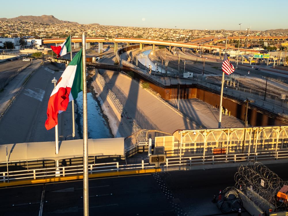 From an aerial view the Mexican and American flags fly over the Rio Grande at the U.S.-Mexico border in El Paso, Texas.