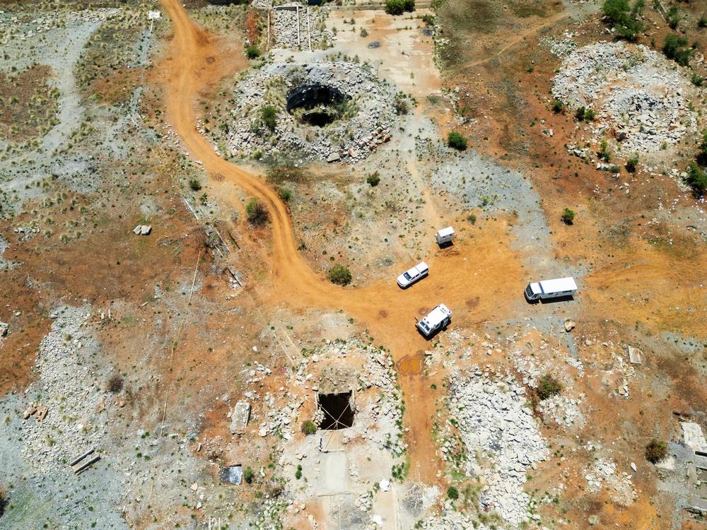 This aerial view shows an open mine shaft where artisanal miners get access to the mine in Stilfontein, South Africa, where there are believed to be hundreds of clandestine miners at a disused mining shaft struggling to survive in grim conditions because of a police operation to force them out.