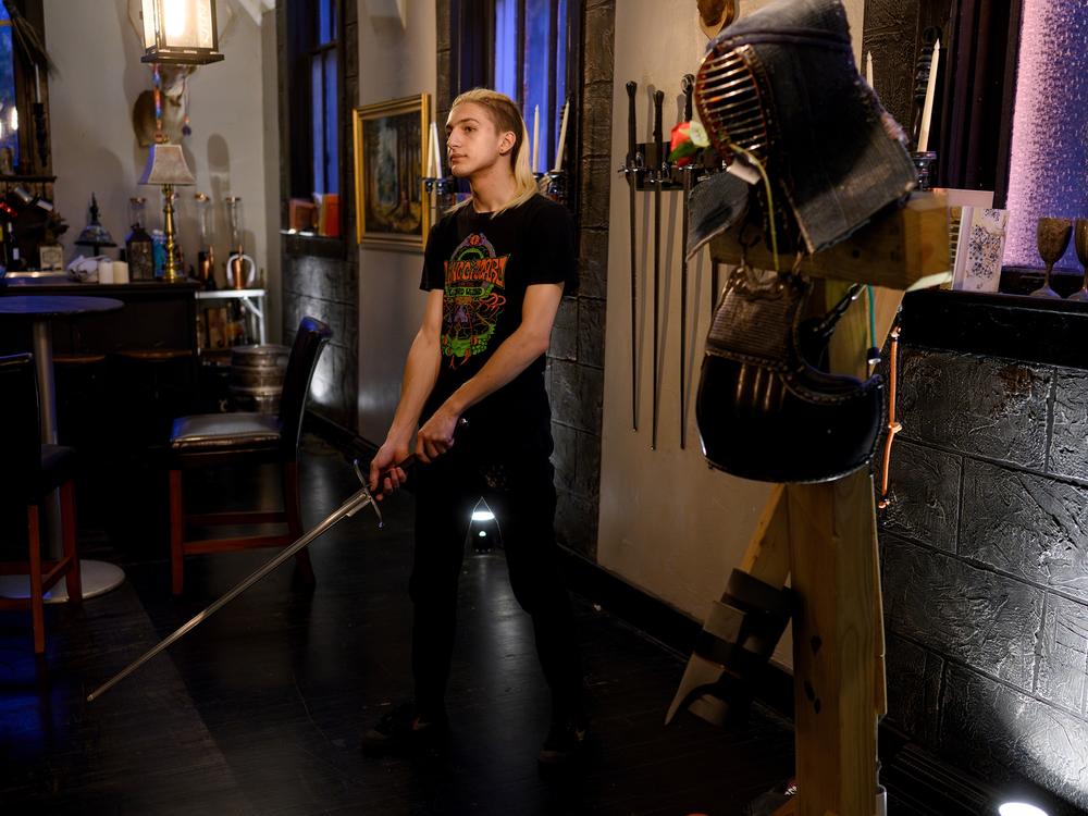 Gaia Ferrency, 17, of Swissvale, Pa., waits for his turn in a longsword tournament as part of 'Friday Night Fights' hosted by he Broken Plow and Pittsburgh Sword Fighters at the Church of Liechtenauer in Creighton, Pa., on Oct. 4, 2024.