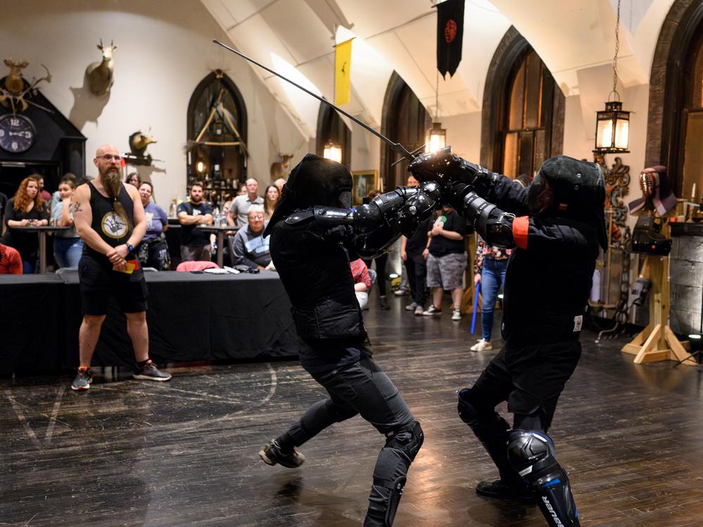 The audience cheers on two sword fighters as they take part in a long-sword tournament hosted by Pittsburgh Sword Fighters.