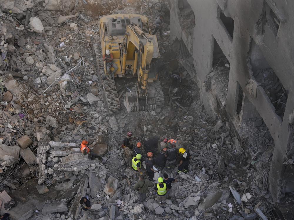 Rescue workers search for victims at the site of an Israeli airstrike that hit central Beirut, Lebanon, Saturday, Nov. 23, 2024.