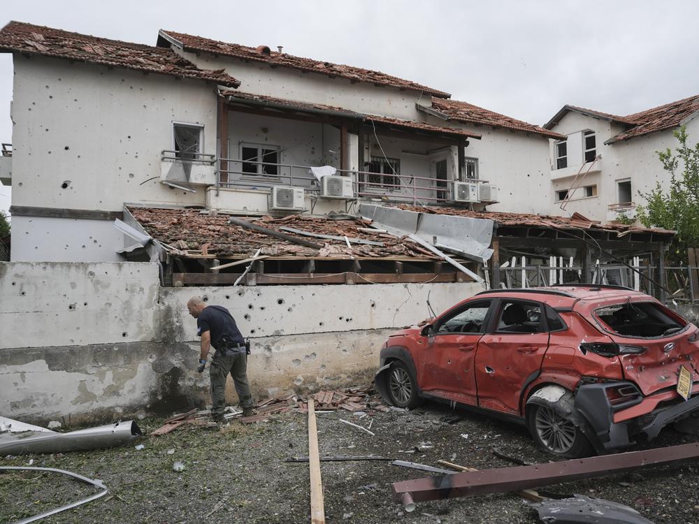 Israeli police bomb squad inspect the site after a missile fired from Lebanon hit the area in Petah Tikva, outskirts of Tel Aviv, Israel, Sunday Nov. 24, 2024.