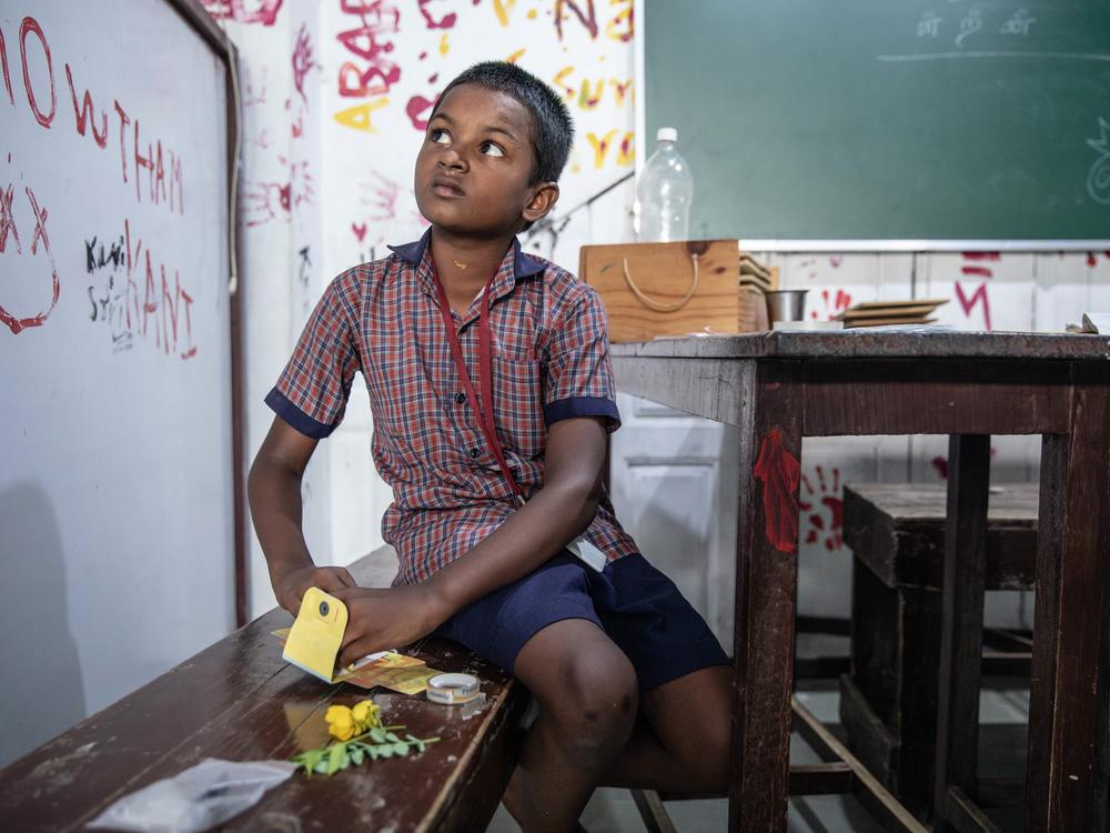 S. Hariraj, 8 years, assembles his foldscope. 