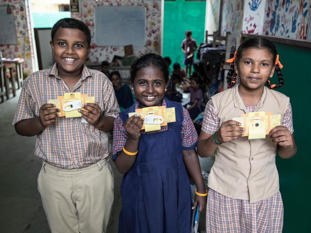 Ramana Rajeesh Kumar, 11, Meenakshi, 8, and Magathi Yazhini, 9, with their Foldscopes. Ramana has been fascinated with bugs for a while. 