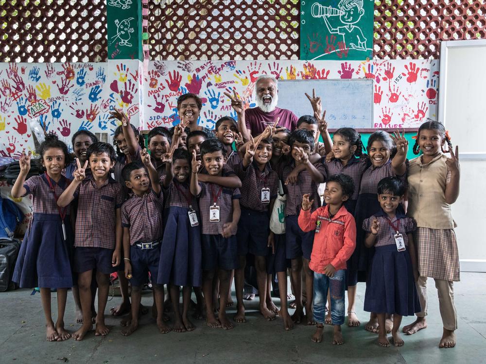 A group photograph of Mo Pandiarajan with his students in the classroom of Eden School, Muthupetty, rural Tamil Nadu. He built the private school in his parents' home and offers classes to kids who are often first-generation learners.