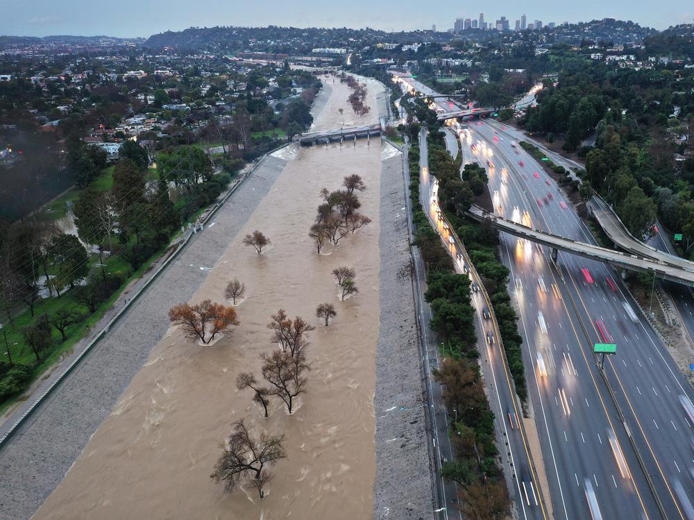 An aerial view of the Los Angeles River swollen by runoff from a long-duration atmospheric river storm in February of 2024 in Los Angeles, California.
