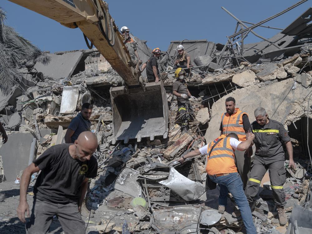 Civil defense members search for survivors at the site of an Israeli strike near Rafik Hariri University Hospital in Beirut, Oct. 22.