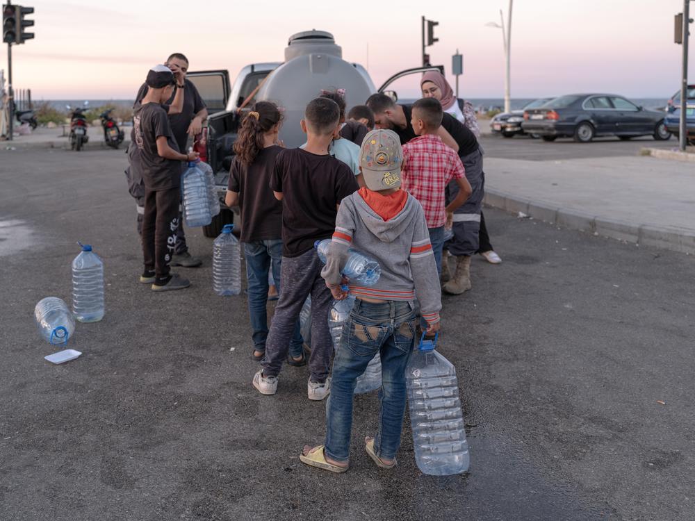 First responders distribute donated water, food and medicine to displaced families in Beirut.