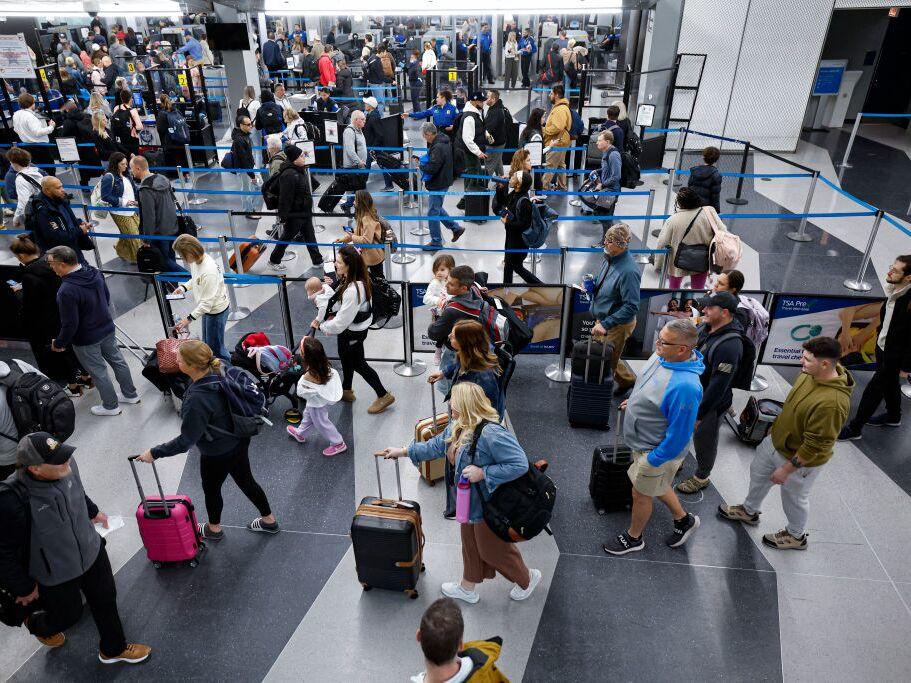 Travelers line up at the security checkpoint at O'Hare International Airport in Chicago on Friday ahead of the Thanksgiving holiday.