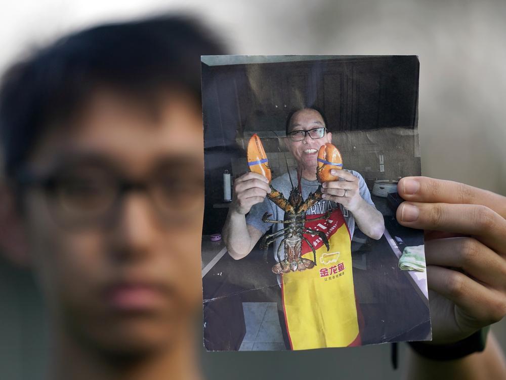 Harrison Li holds a photo of his father, Kai Li, on Jan. 23, 2024, in Palo Alto, California.