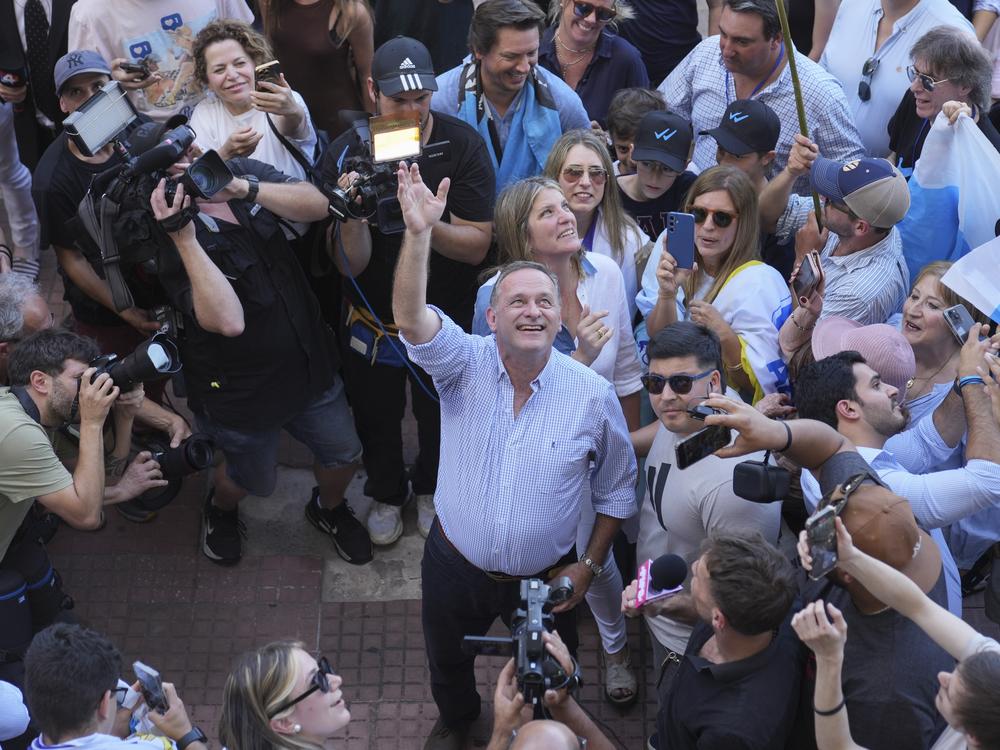 Alvaro Delgado, candidate for the ruling National Party, waves after voting in the presidential run-off election in Montevideo, Uruguay  on Sunday.