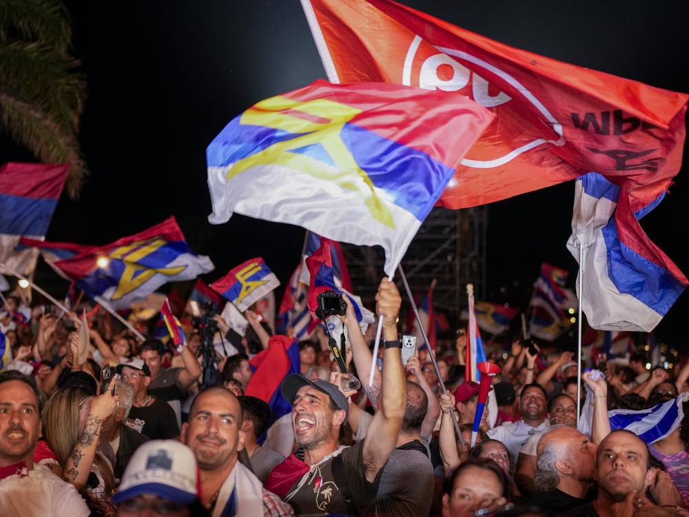 Supporters of Yamandu Orsi, candidate for the Broad Front (Frente Amplio), celebrate early results after polls closed in the presidential run-off election in Montevideo, Uruguay on Sunday.