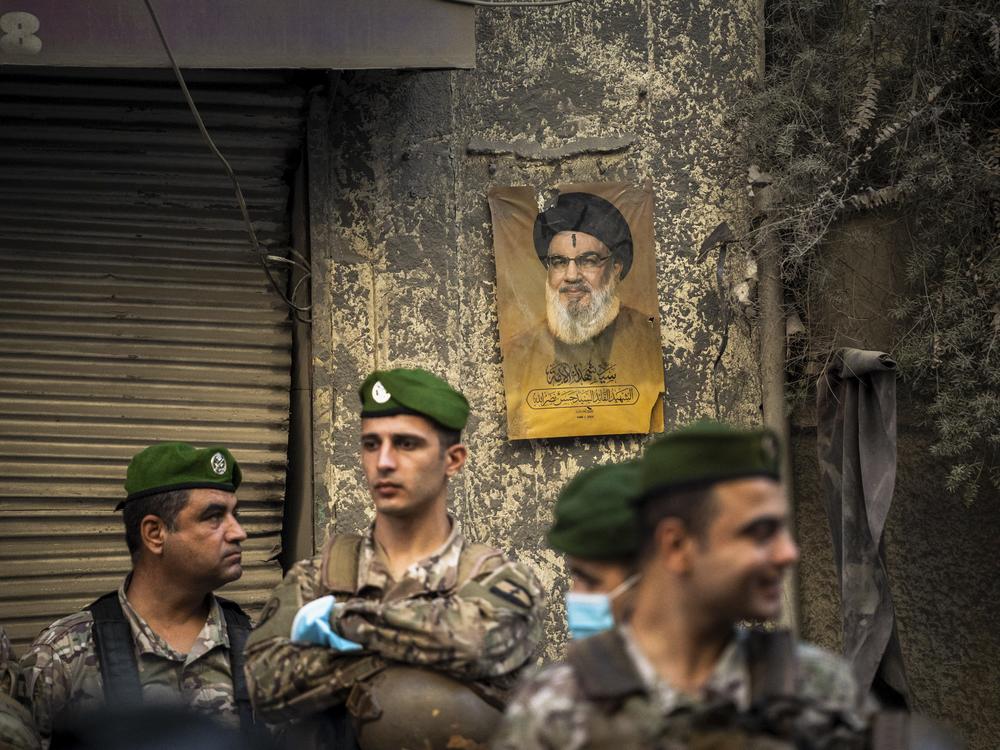 A portrait of Hassan Nasrallah, Hezbollah's former leader who was killed earlier this year, hangs on the wall at the site of an Israeli strike in Basta, central Beirut, Nov. 23.