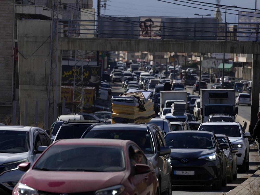 Displaced residents sit in traffic as they return to their villages following a ceasefire between Israel and Hezbollah that went into effect on Wednesday in Ablah, eastern Lebanon.