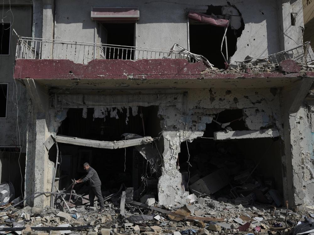 A man removes debris from his destroyed shop after returning to his village of Hanouiyeh, southern Lebanon on Thursday following a ceasefire between Israel and Hezbollah that went into effect on Wednesday.