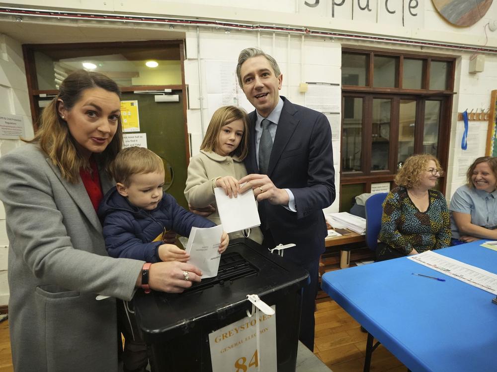 Irish Prime Minister and Fine Gael leader Simon Harris, center, accompanied by his wife Caoimhe and children Cillian and Saoirse, casts his vote at Delgany National School, County Wicklow, as voters go to the polls for the 2024 General Election in Ireland, on Friday.