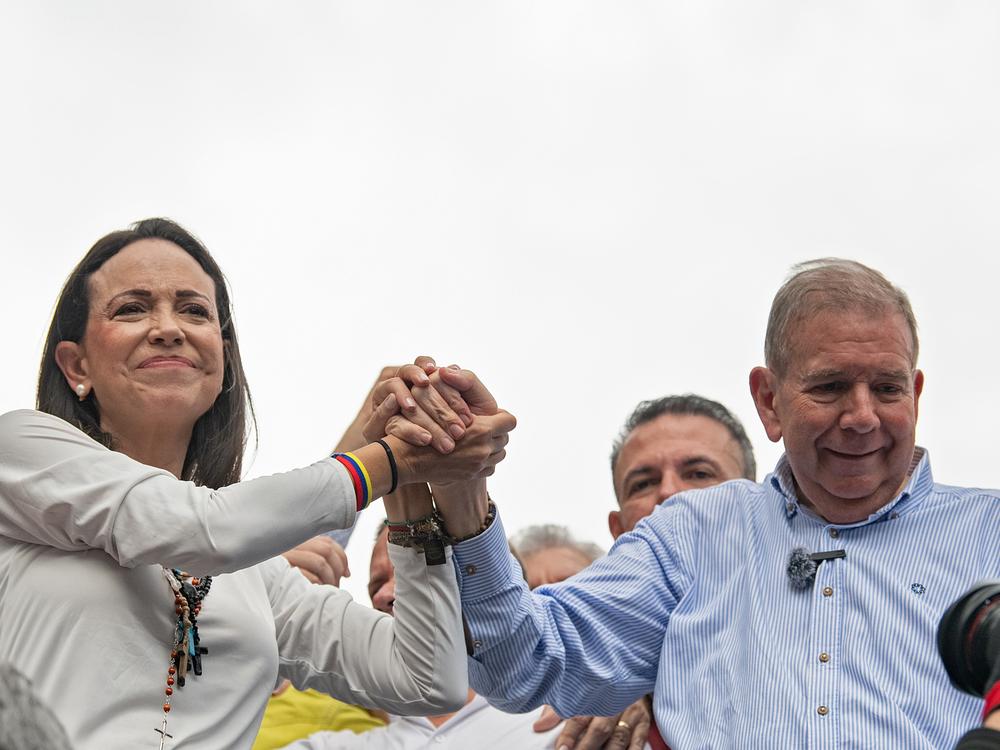 Opposition leader María Corina Machado and opposition presidential candidate Edmundo González join hands during a protest against the result of the presidential election on July 30 in Caracas.