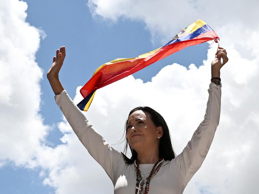 Venezuelan opposition leader Maria Corina Machado waves a Venezuelan flag during a rally in Caracas on August 28, 2024.