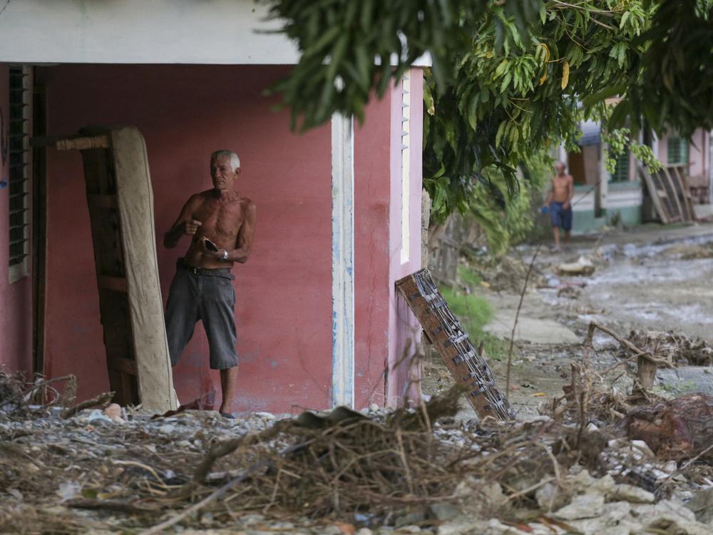 A man dries a mattress after Hurricane Oscar hit the town of Imias in Guantanamo province, Cuba, on October 30, 2024. Oscar strengthened from a depression to a hurricane in just five hours.
