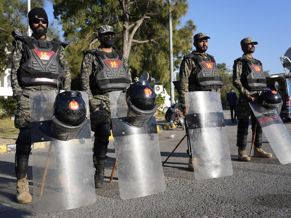 Paramilitary soldiers stand guard along roadside to ensure security in Islamabad, Pakistan on Wednesday.