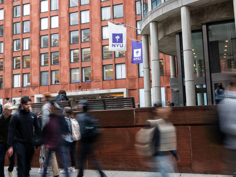 People walk by New York University in October 2023 in New York City. The university has a large international student enrollment.