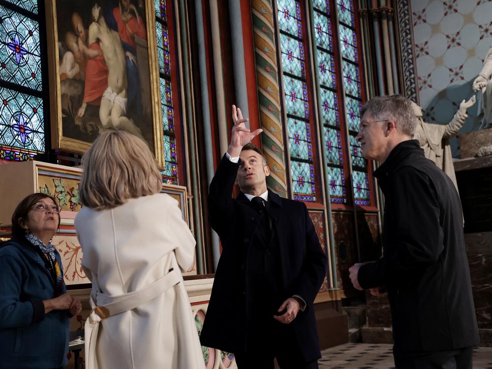 French President Emmanuel Macron and his wife Brigitte Macron (second from left), accompanied by President of the 