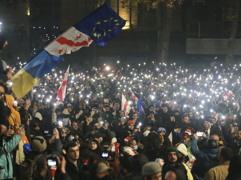 Demonstrators stand in front of police during a rally outside the parliament's building to protest the government's decision to suspend negotiations on joining the European Union for four years in Tbilisi, Georgia, on Saturday, Nov. 30, 2024.
