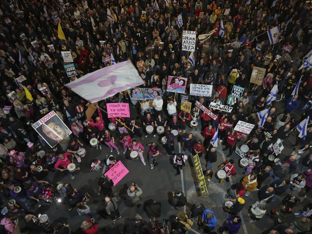 People shout slogans during a protest against Prime Minister Benjamin Netanyahu's government and call for the release of hostages held in the Gaza Strip by the Hamas militant group, in Tel Aviv, Israel, Saturday Nov. 30, 2024.(AP Photo/Ohad Zwigenberg)